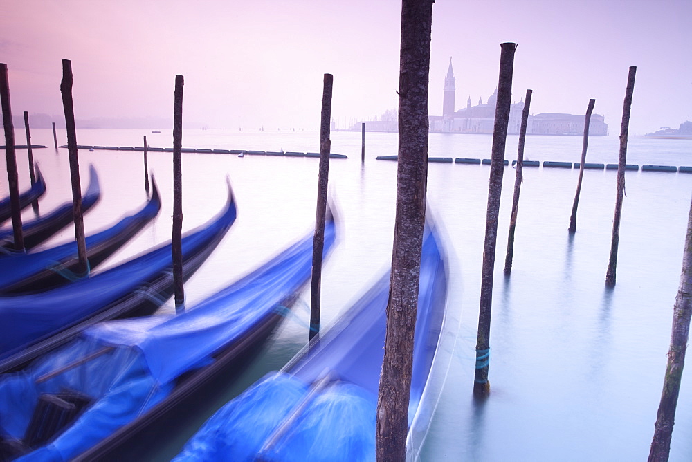 Gondolas moored by St. Marks Square, looking across to Isola di San Giorgio Maggiore in the early morning, Venice, UNESCO World Heritage Site, Veneto, Italy, Europe