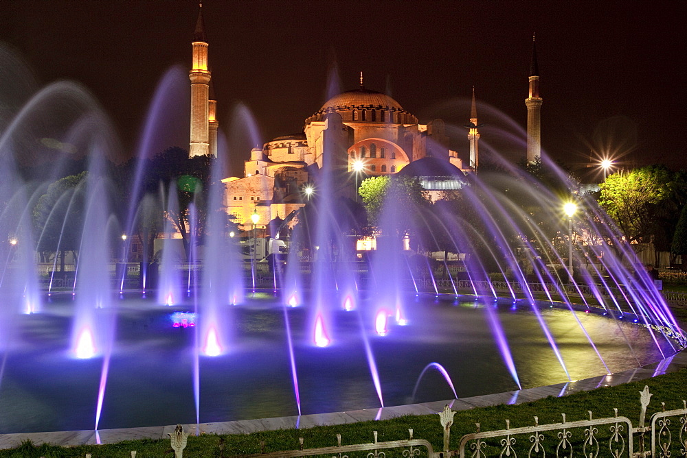 Coloured fountains at night in Sultan Ahmet Park, a favourite gathering place for locals and tourists, looking towards the Blue Mosque, Istanbul, Turkey, Europe