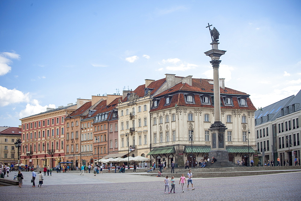 Tourists walk across Castle Square Plac Zamkowy, site of Sigismund's Column and Royal Castle, Old Town rebuilt after World War II, UNESCO World Heritage Site, Warsaw, Poland, Europe