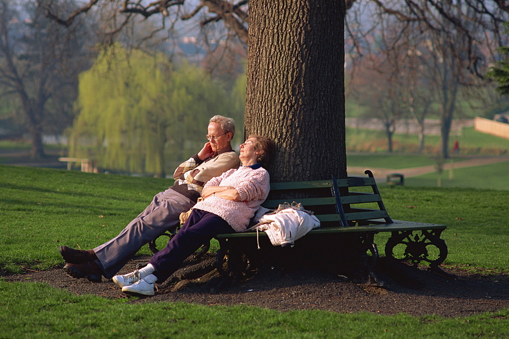 Elderly couple enjoying the spring sunshine, Castle Park, Colchester, Essex, England, United Kingdom, Europe