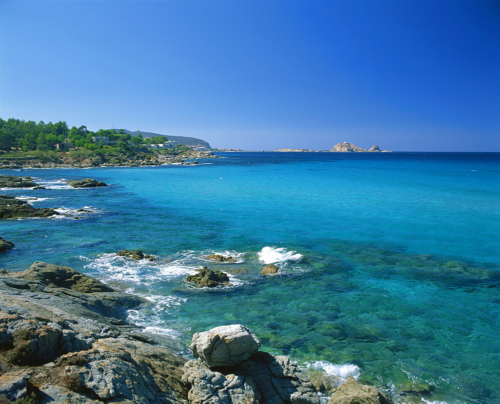 Distant view to the Ile de la Pietra, across calm turquoise sea from Ile-Rousse, Corsica, France, Mediterranean, Europe