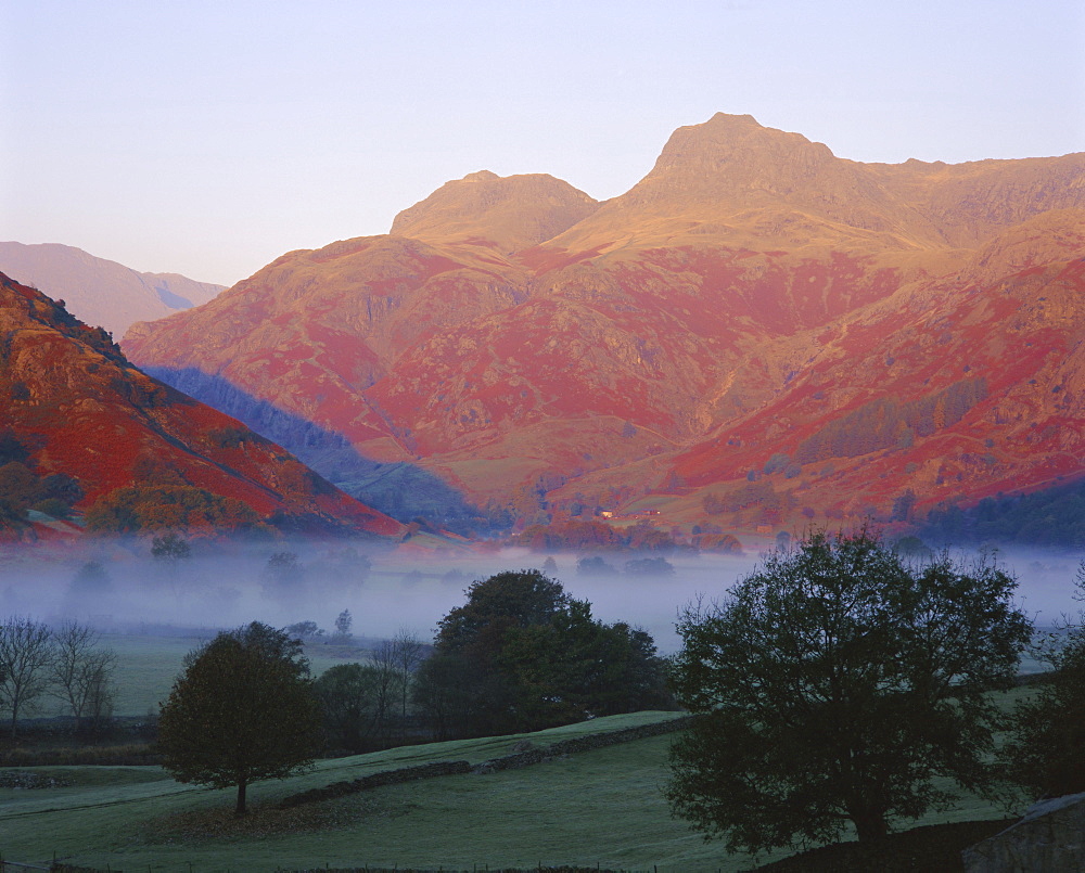 Morning mist, Great Langdale from Chapel Stile, Langdale Pikes in early morning light, Lake District National Park, Cumbria, England, UK