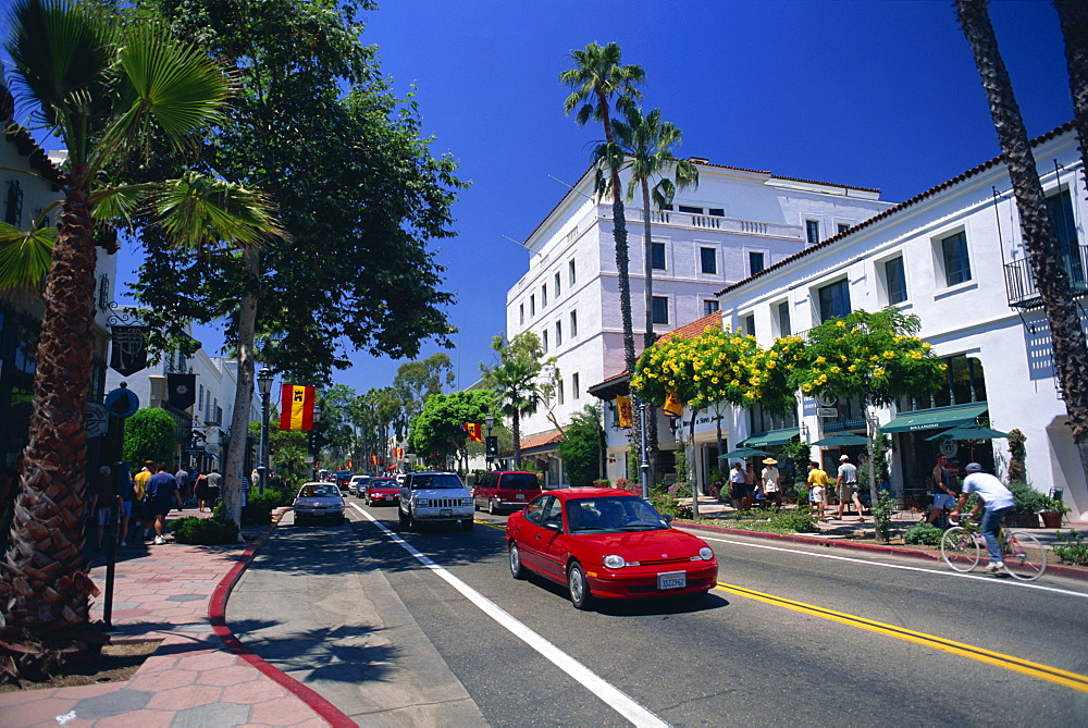 Red car and flowering trees on State Street in Santa Barbara, California, United States of America, North America