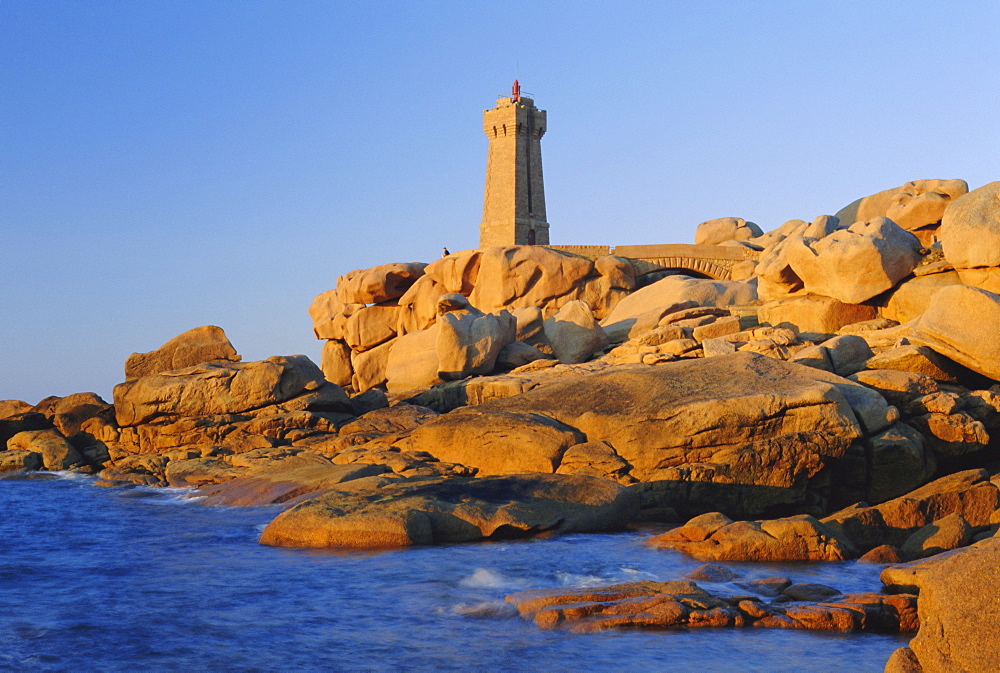 Lighthouse and pink granite rocks at sunset, Ploumanach, Cotes d'Armor, Brittany, France, Europe