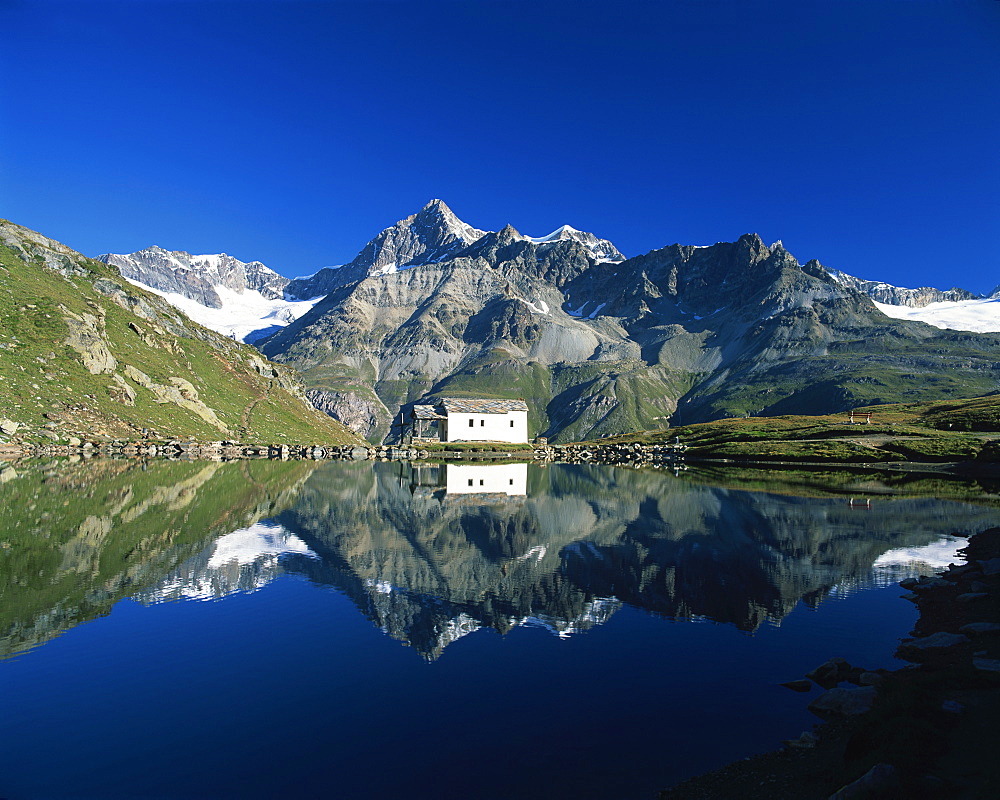 White chapel and Ober Gabelhorn reflected in the Schwarzsee, Zermatt, Valais, Switzerland, Europe