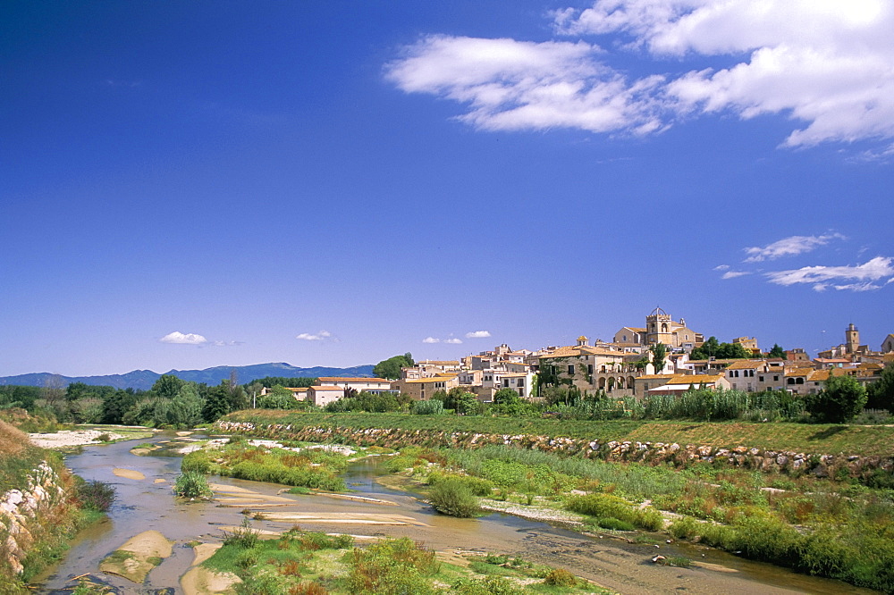 View to village across river, Peralada, near Figueras, Gerona, Catalonia (Cataluna) (Catalunya), Spain, Europe