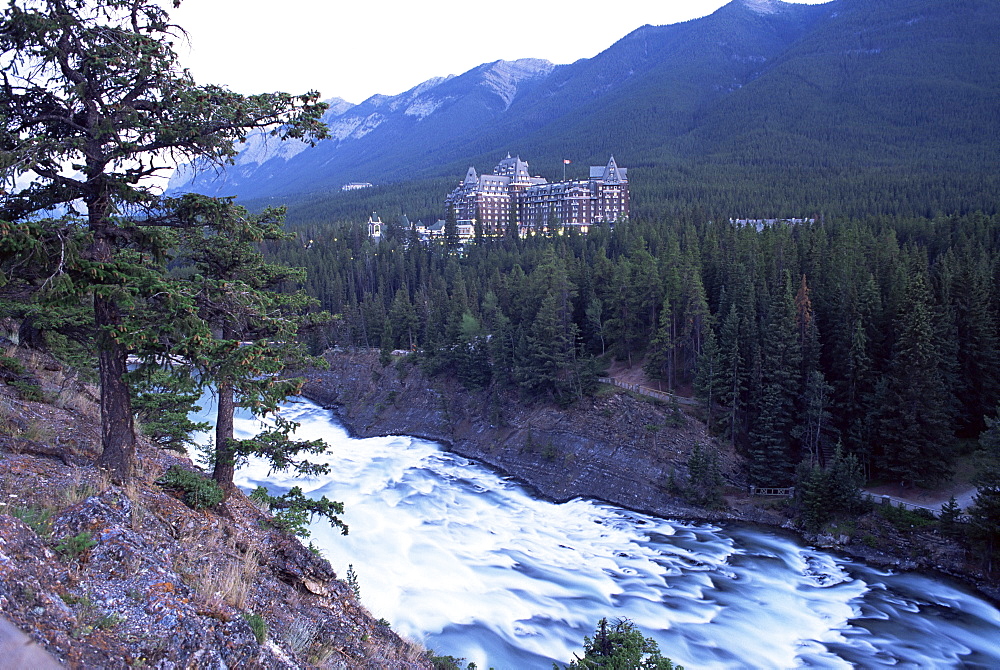 Banff, the Bow Falls and prestigious Banff Springs Hotel, at dusk, Banff National Park, UNESCO World Heritage Site, Alberta, Canada, North America