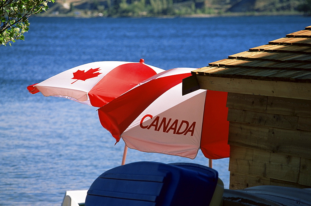 Patriotic umbrellas on the shore of Okanagan Lake, Sun-Oka Beach Provincial Park, near Penticton, British Columbia, Canada, North America