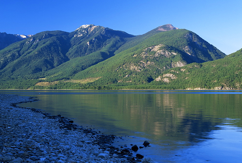 The rocky western shore of Kootenay Lake in the evening, near Kaslo, British Columbia (B.C.), Canada, North America