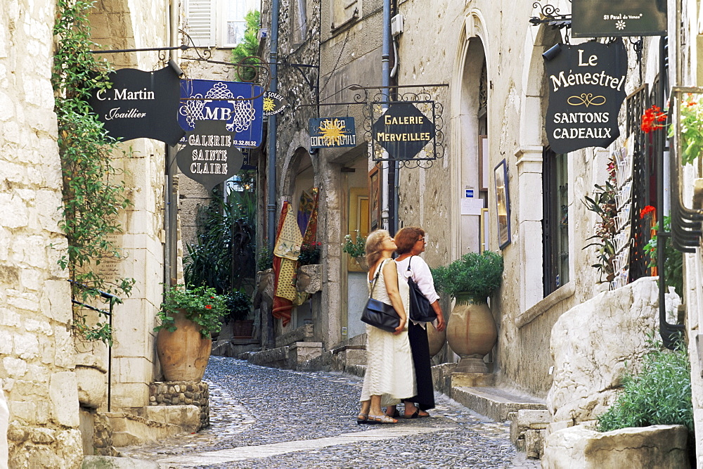 Window shopping in medieval village street, St. Paul de Vence, Alpes-Maritimes, Provence, France, Europe