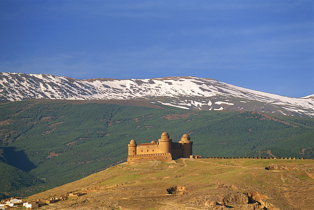 View to distant medieval castle beneath the snow-capped Sierra Nevada, La Calahorra, Granada, Andalucia (Andalusia), Spain, Europe