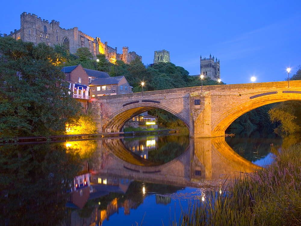 View to the illuminated castle and cathedral across the River Wear below Framwellgate Bridge, Durham, County Durham, England, United Kingdom, Europe