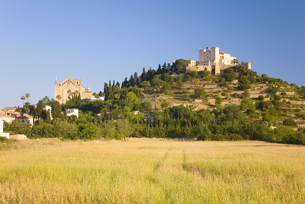 View across fields to the parish church and hilltop Sanctuary of Sant Salvador, Arta, Mallorca, Balearic Islands, Spain, Europe