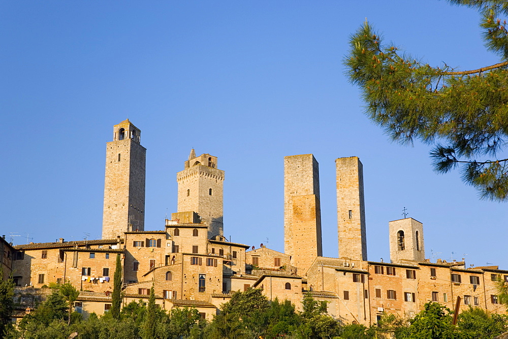 Medieval towers lit by the rising sun, San Gimignano, UNESCO World Heritage Site, Siena, Tuscany, Italy, Europe