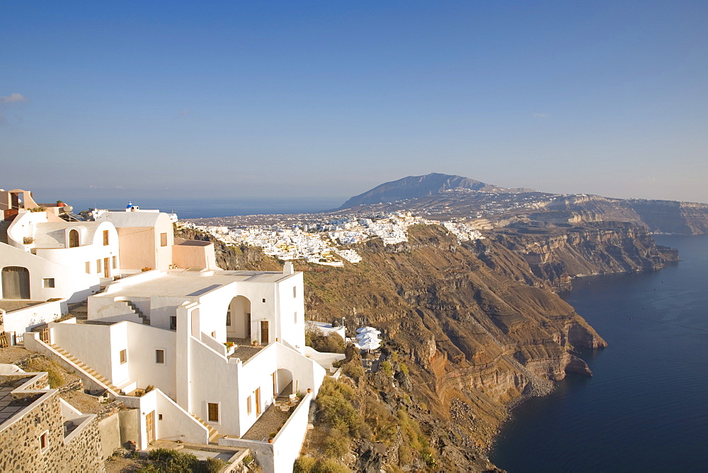 View along volcanic cliffs towards distant Fira, Imerovigli, Santorini (Thira) (Thera), Cyclades Islands, South Aegean, Greek Islands, Greece, Europe