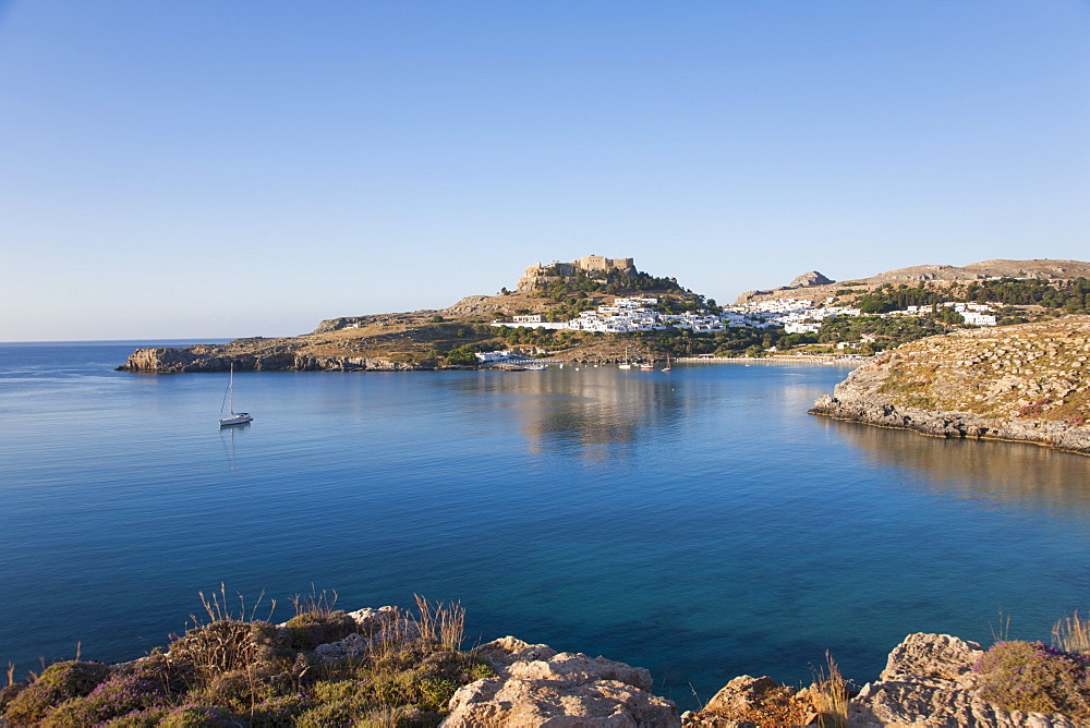 View across the tranquil waters of Lindos Bay, Lindos, Rhodes, Dodecanese Islands, South Aegean, Greece, Europe