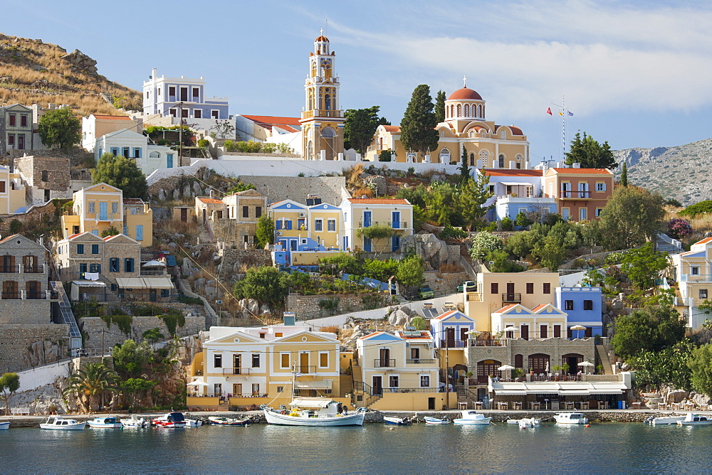 View over harbour to colourful houses and church, Gialos (Yialos), Symi (Simi), Rhodes, Dodecanese Islands, South Aegean, Greece, Europe