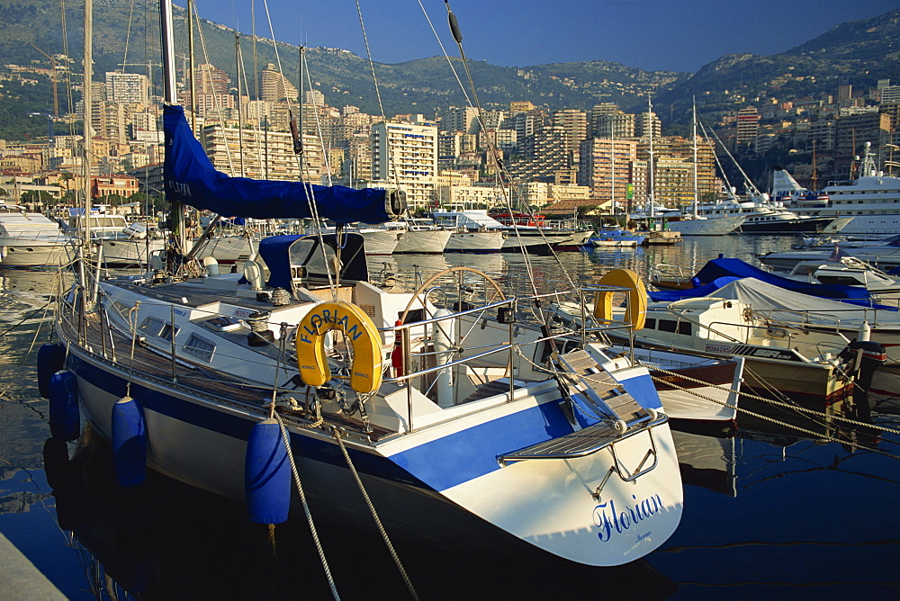 Yacht in foreground, the harbour, Monaco. Cote d'Azur, Mediterranean, Europe