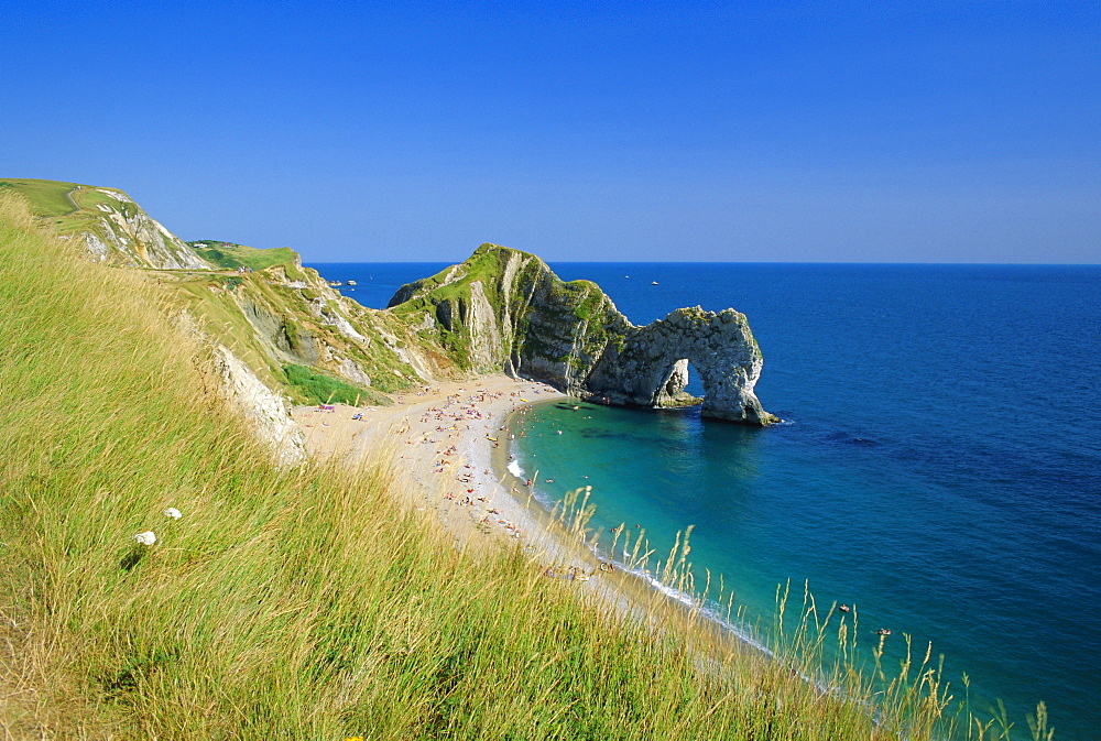 View from coastal path of Durdle Door, arch of Purbeck limestone, near West Lulworth, Dorset, England, UK