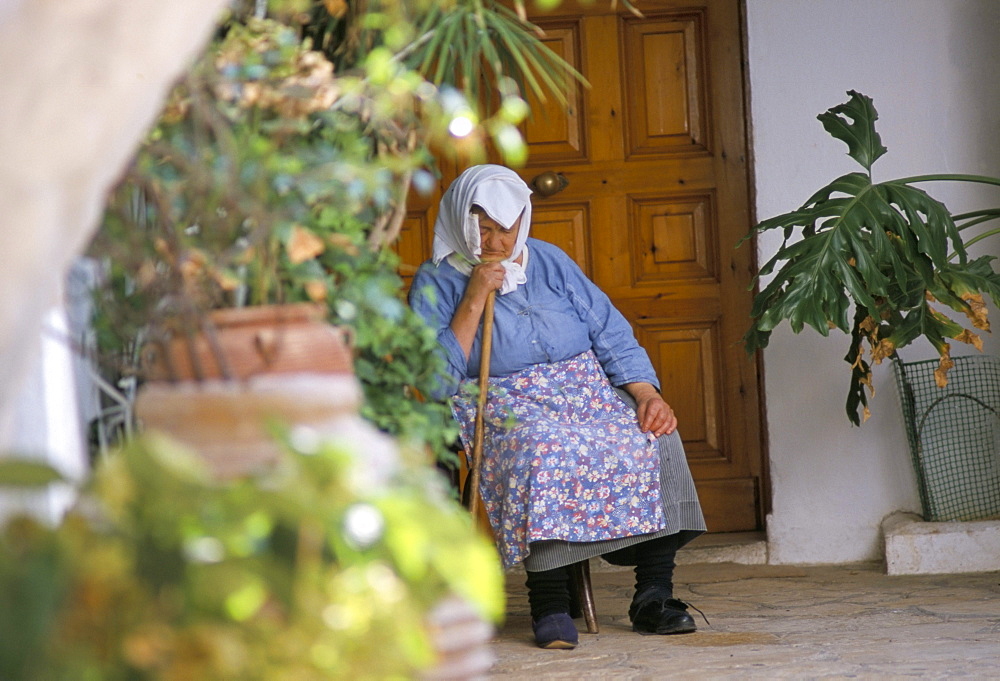 Old woman dozing at monastery, Paleokastritsa, Corfu, Greek Islands, Greece, Europe