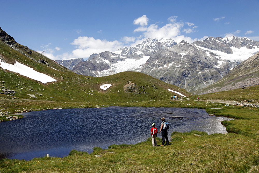 Two hikers at Schwarzsee, Zermatt, Valais, Swiss Alps, Switzerland, Europe