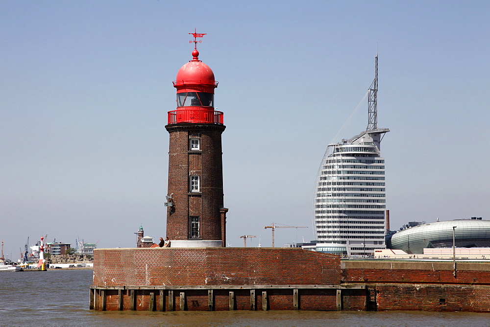 Lighthouse at old harbour, and Atlantic Hotel Sail City, Bremerhaven, Bremen, Germany, Europe