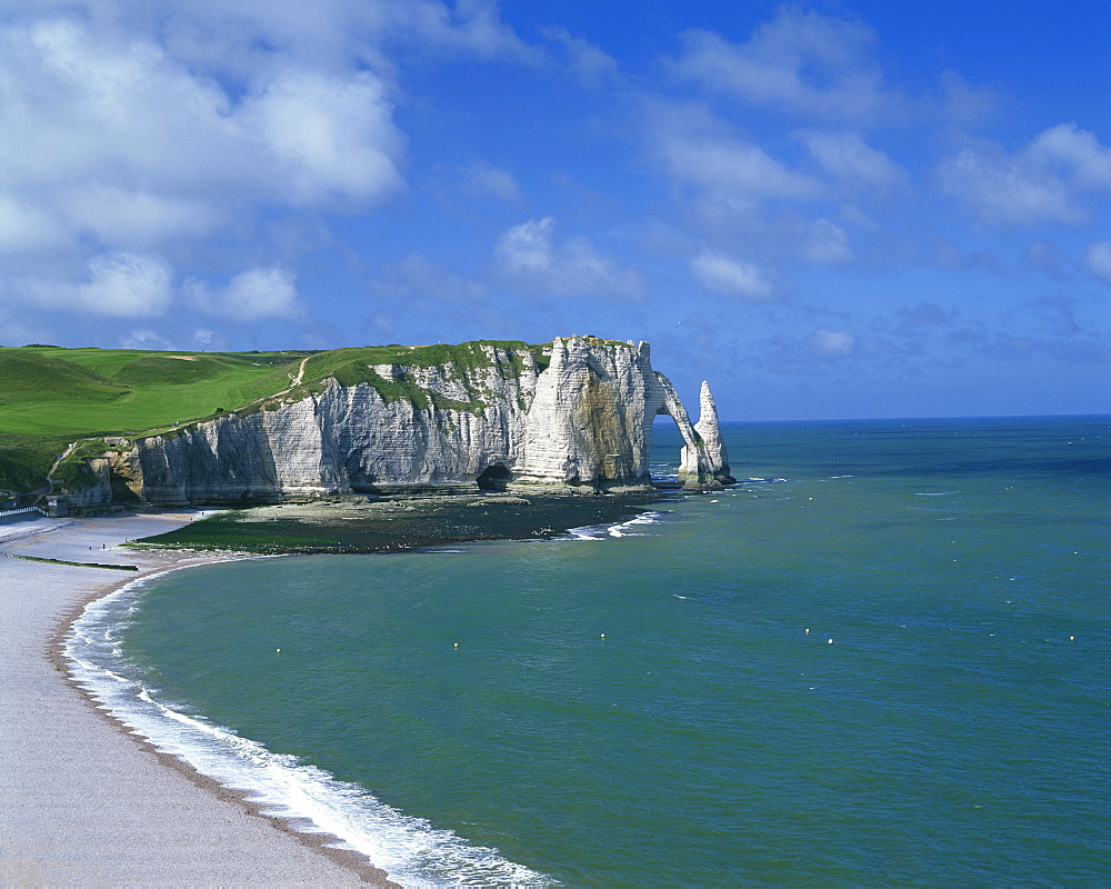 Beach, cliffs and rock arch, known as the Falaises, on the coast near Etretat, Haute Normandie, France, Europe