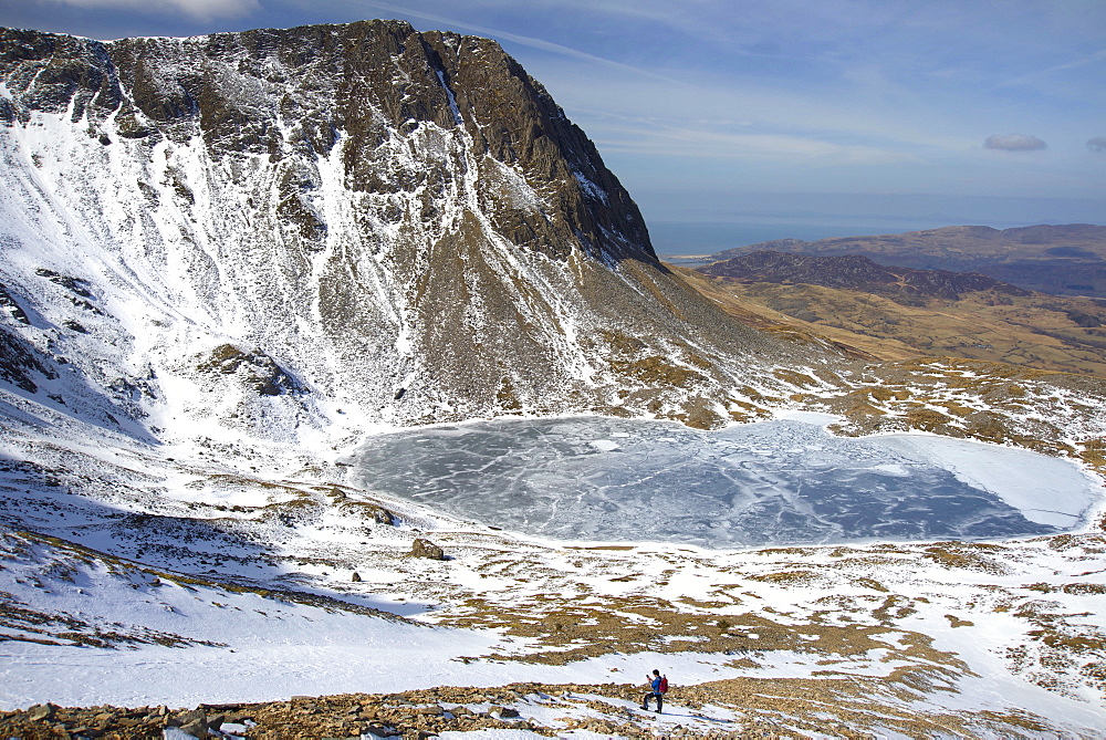 The frozen Llyn Y Gadair below summit of Cyfrwy, 811m, near Cadair Idris, Snowdonia National Park, Wales, United Kingdom, Europe 