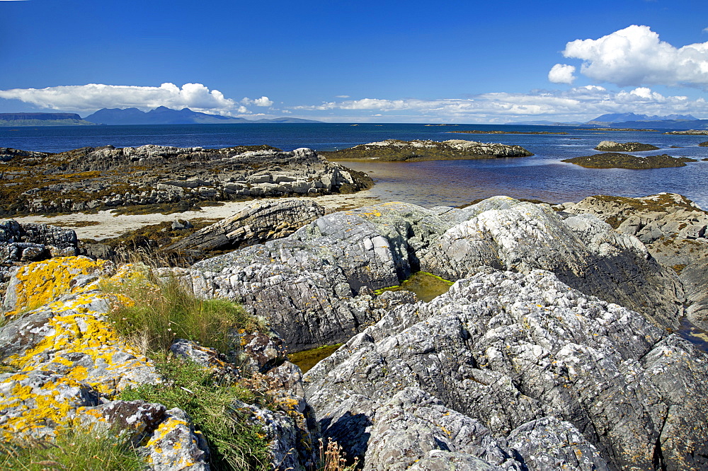 West coast of the Scottish Highlands looking west towards the Small Isles with Eigg and Rhum on the far left and the Isle of Skye to the right on the horizon, Scotland, United Kingdom, Europe