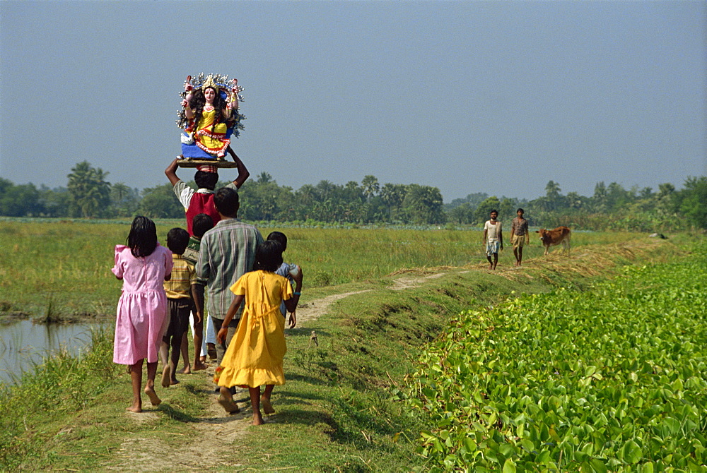 Group delivering Hindu god model to village, Parganas District, West Bengal, India, Asia