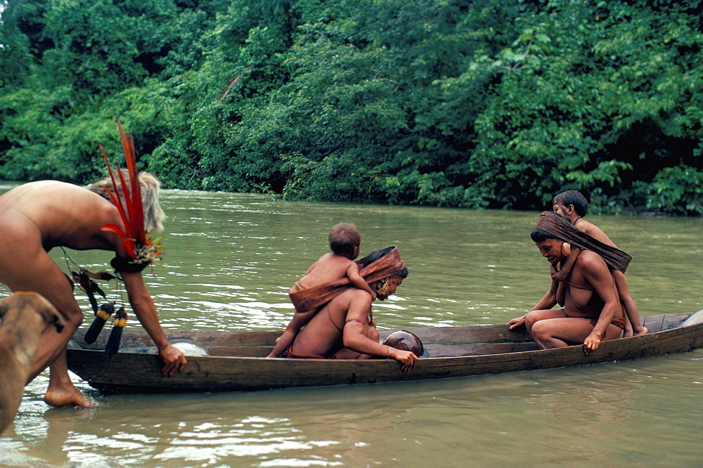 Yanomami crossing river in boat, Brazil, South America