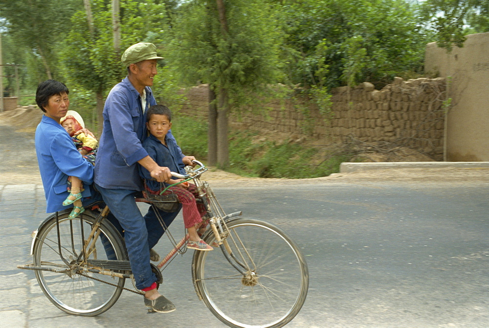 Family riding on a bicycle in Ningxia, China, Asia