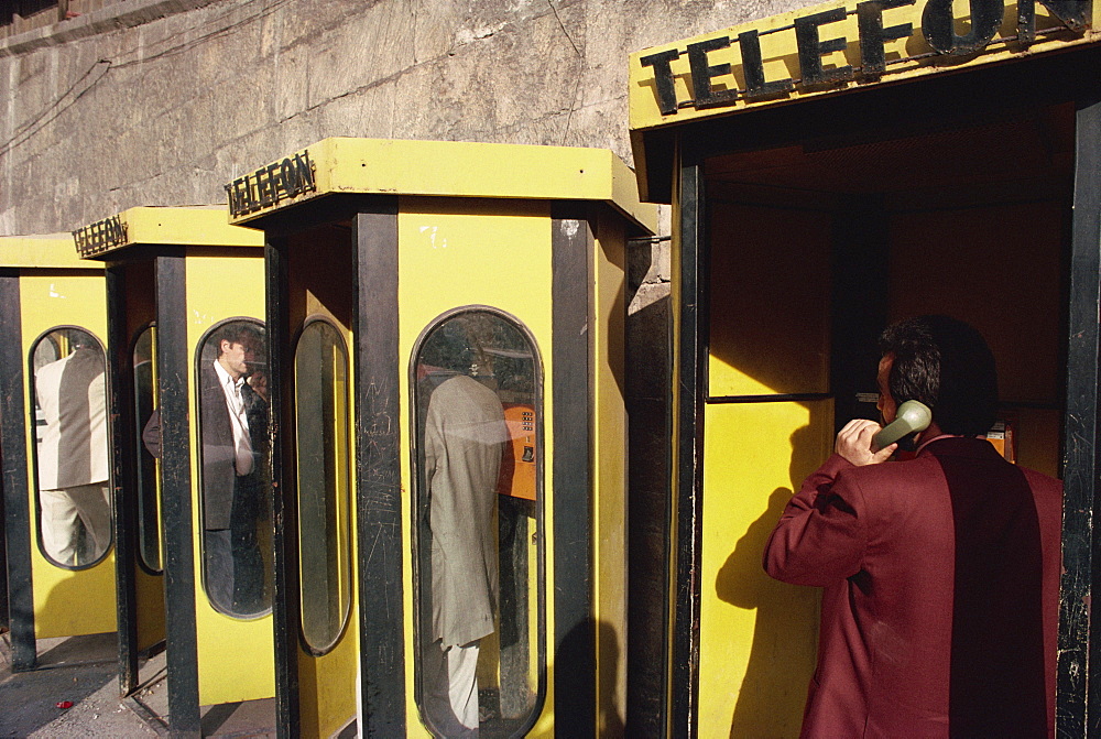 People in telephone kiosks on Galata Bridge, Istanbul, Turkey, Europe