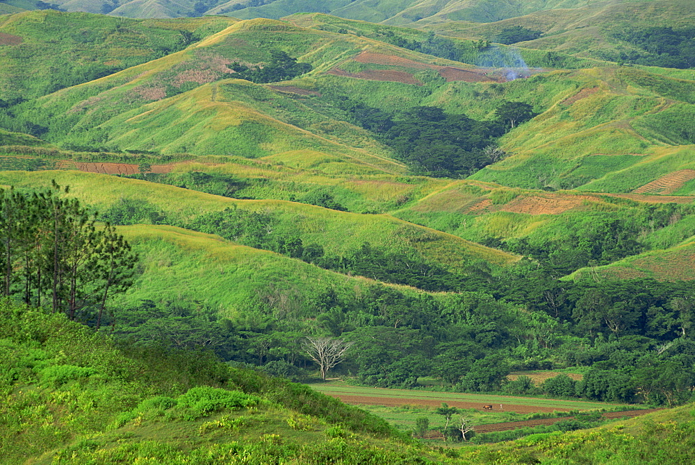 Landscape of green hills and farmland in the Sigatoka River Valley, Fiji, Pacific