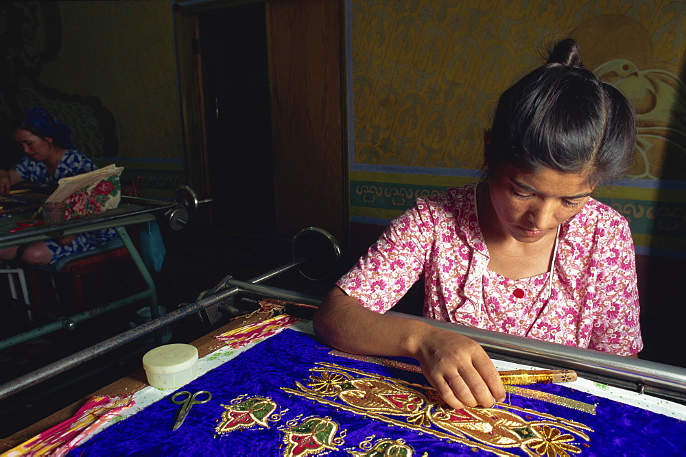 Worker in embroidery factory, Bukhara, Uzbekistan, Central Asia, Asia