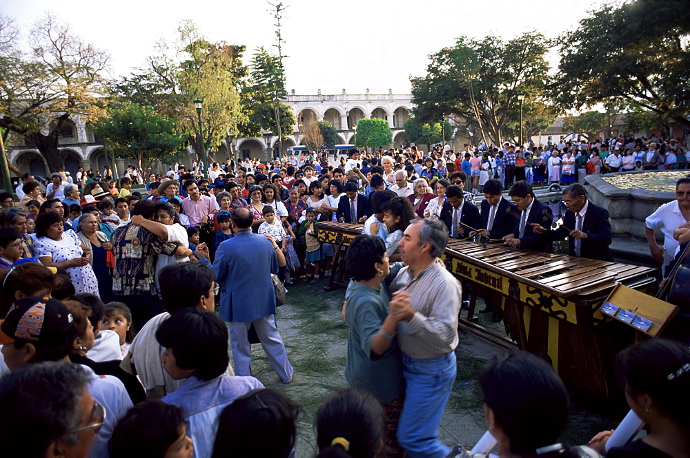 Sunday dancing in Parque Central, Antigua, Guatemala, Central America