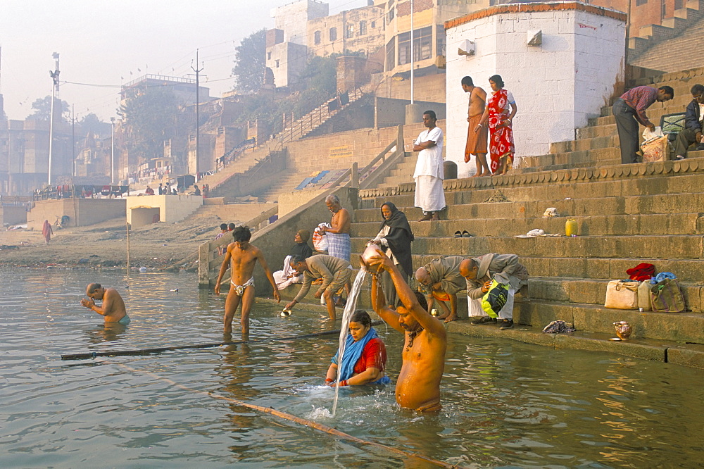 Men and women washing in the River Ganges at Scindia Ghat, Varanasi (Benares), Uttar Pradesh, India, Asia