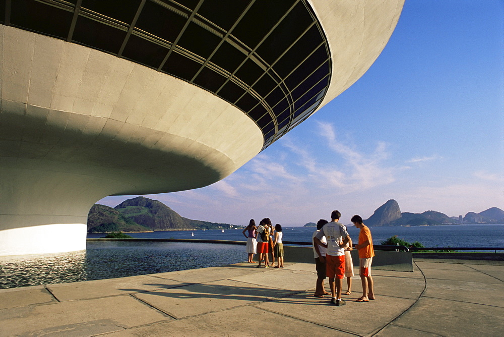 People looking at view across bay to Rio from Museo de Arte Contemporanea, by Oscar Niemeyer, Rio de Janeiro, Brazil, South America