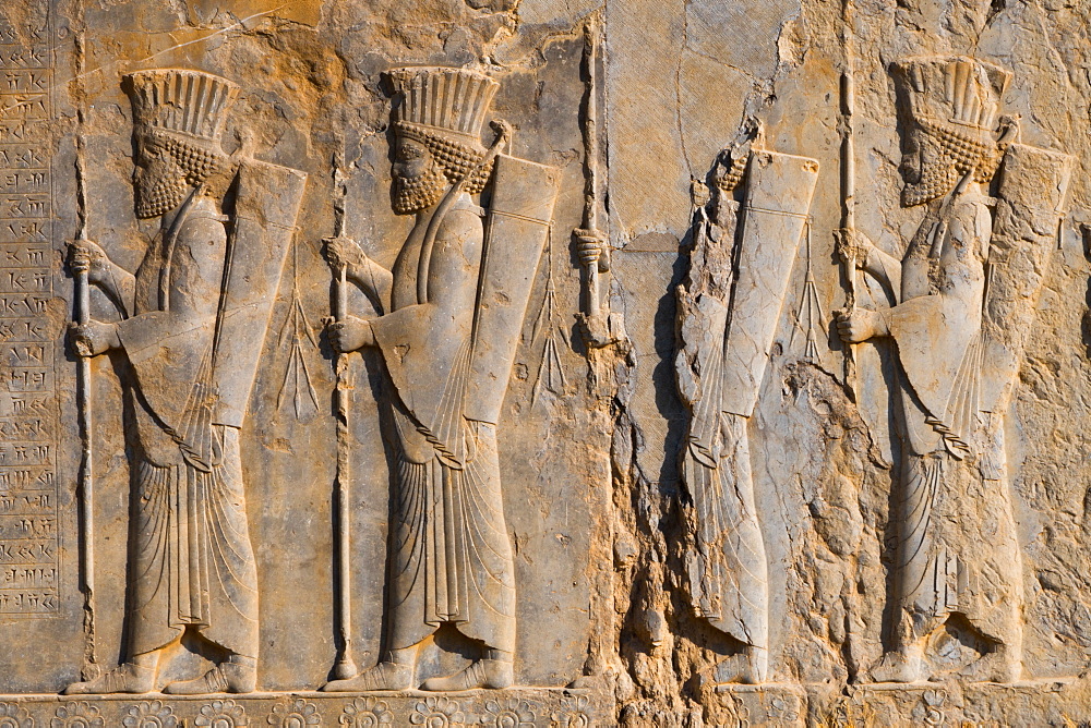 Carved relief of four Royal Persian Guards, facade of Private Palace of Darius the Great (Tachara), Persepolis, UNESCO World Heritage Site, Iran, Middle East