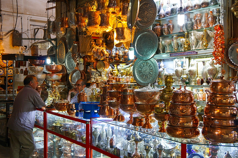 Two bazaaris chatting over the counter of a metalwork shop, Grand Bazaar, Isfahan, Iran, Middle East