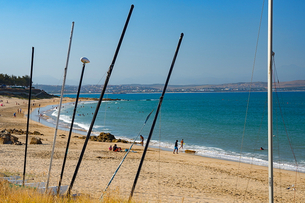 Beach seen though masts of beached boats, Mossel Bay, Western Cape, South Africa, Africa