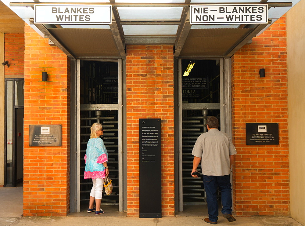 Outside the entrance to the Apartheid Museum showing the old whites and non-whites signs from apartheid era, Johannesburg, South Africa, Africa