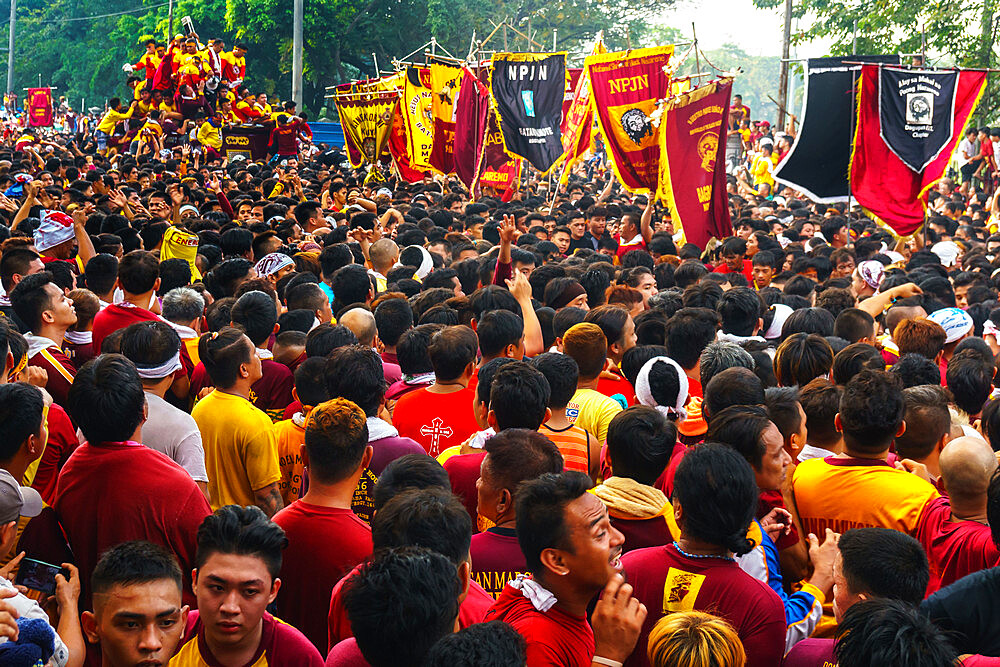 Flag carriers lead final procession of the Black Cross and Jesus at annual Feast of the Black Nazarene across Manila, Philippines, Southeast Asia, Asia