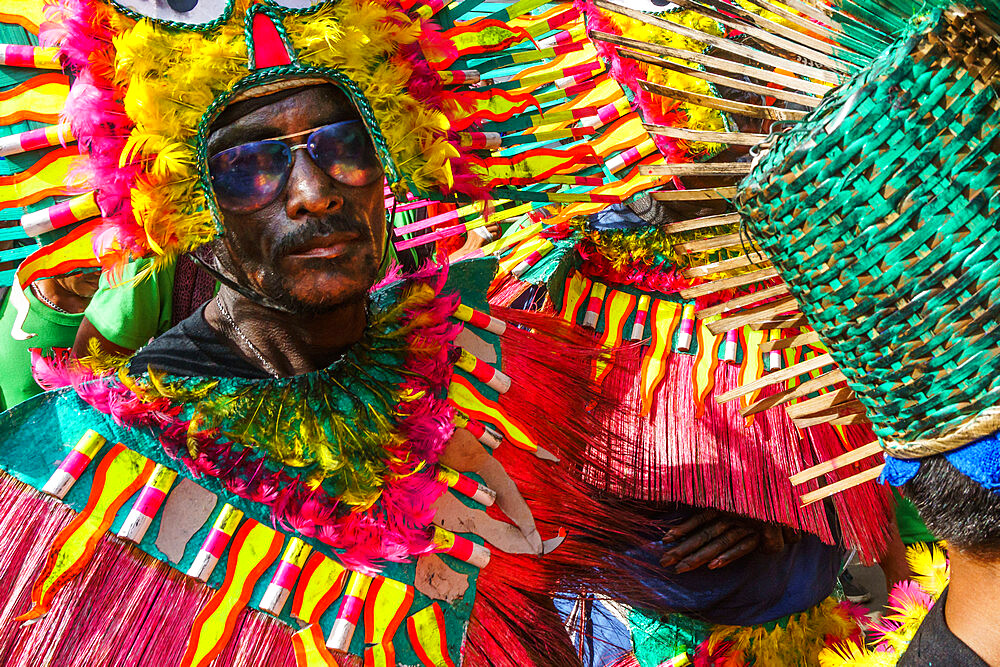 Cool participant in dark glasses and flamboyant coloured dress at the annual Ati-Atihan Festival, Kalibo Island, Philippines, Southeast Asia, Asia