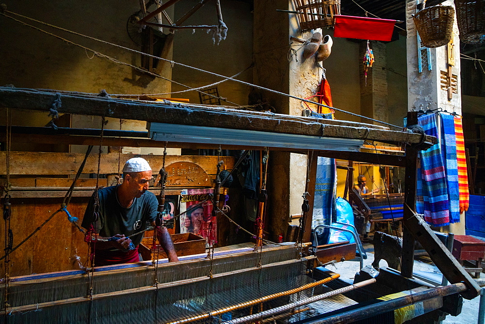 Weaver at work at loom in shop in the Old City (Medina) of Fez, UNESCO World Heritage Site, Morocco, North Africa, Africa