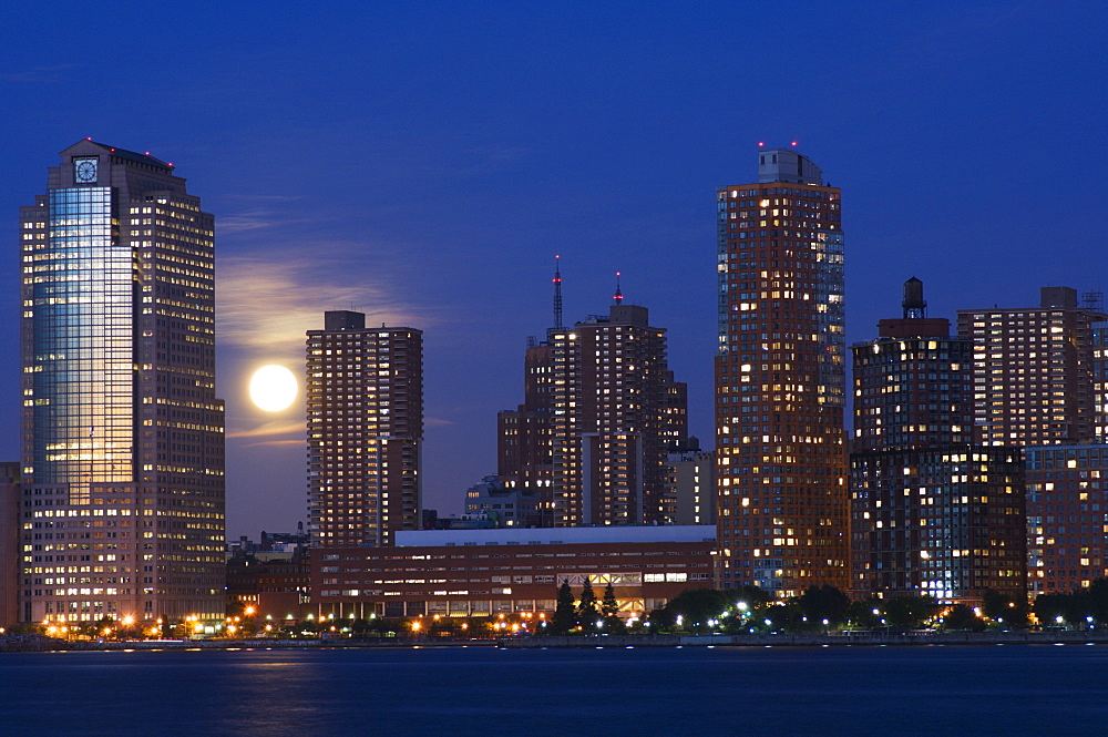 Full moon rising over Lower Manhattan skyline across the Hudson River, New York City, New York, United States of America, North America