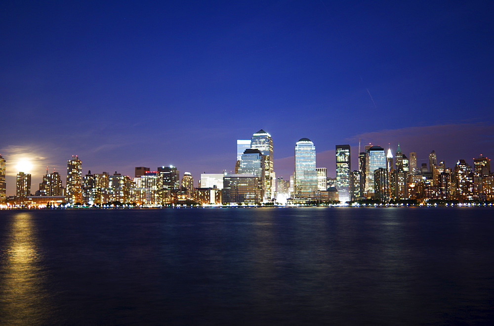 Full moon rising over Lower Manhattan skyline across the Hudson River, New York City, New York, United States of America, North America