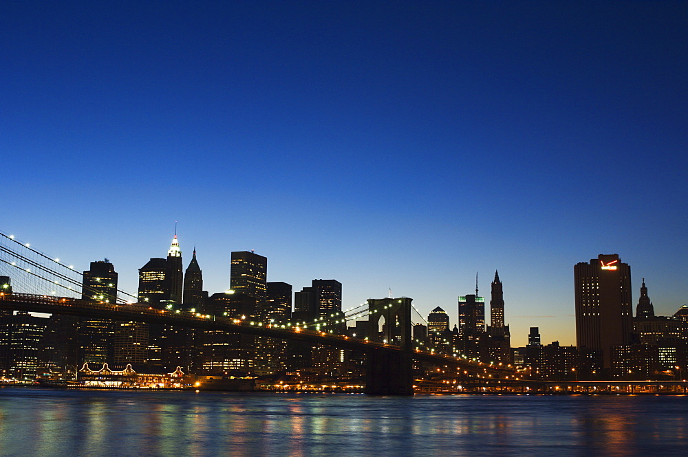 Manhattan skyline and Brooklyn Bridge at dusk, New York City, New York, United States of America, North America