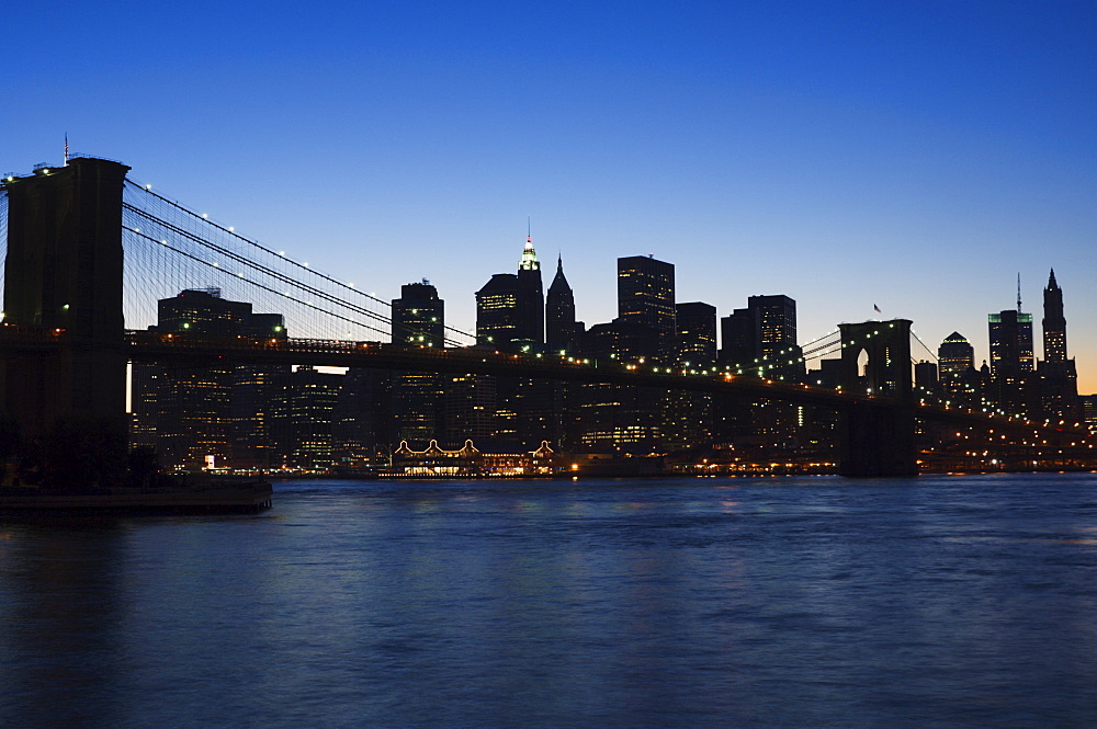 Manhattan skyline and Brooklyn Bridge at dusk, New York City, New York, United States of America, North America