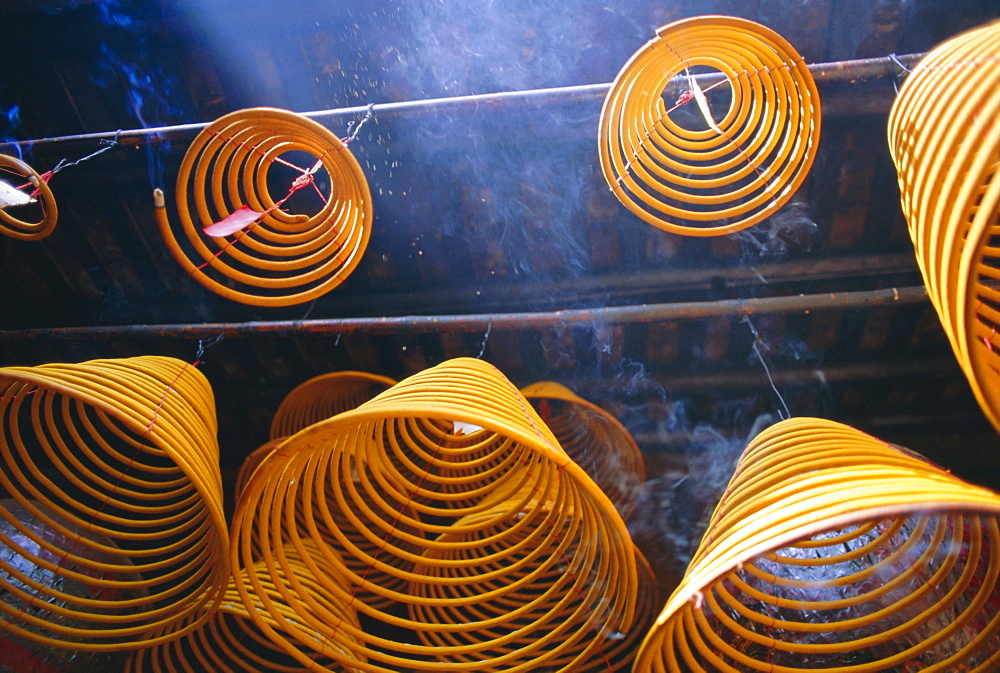 Burning incense at Kuanyin Temple, Ma Hang Village, Stanley Bay, Hong Kong Island, Hong Kong, China